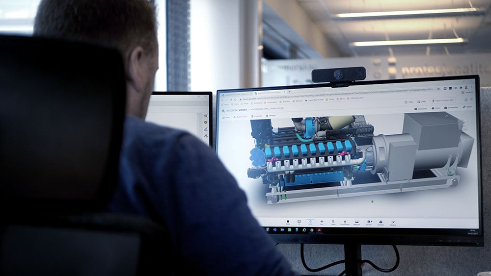 Engineer working at a computer on power system design.